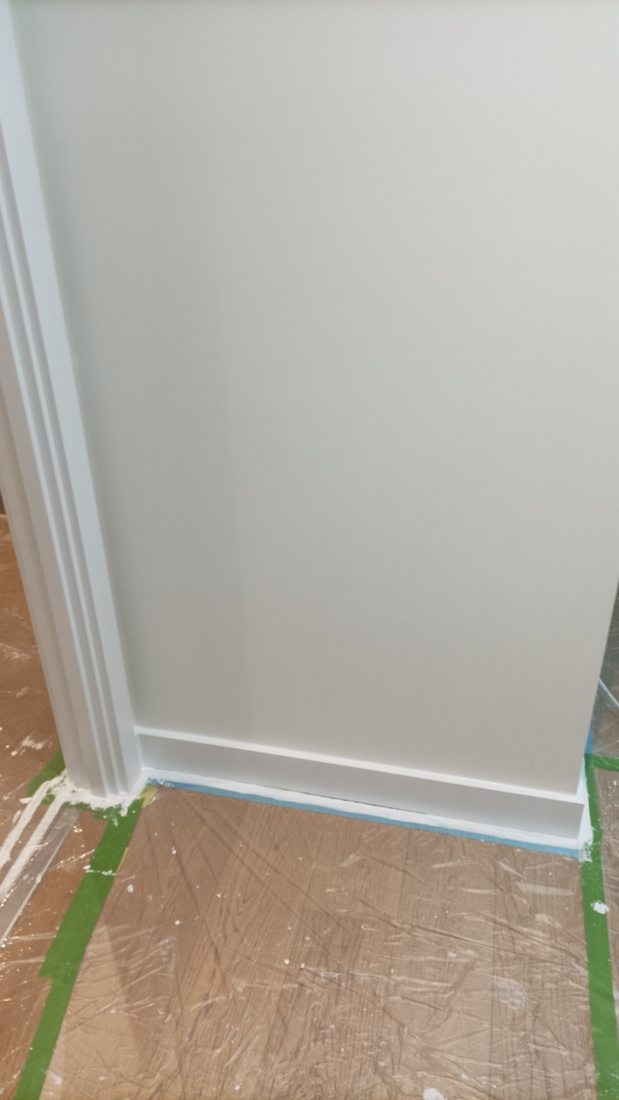 Interior wall with masking tape at the skirting board