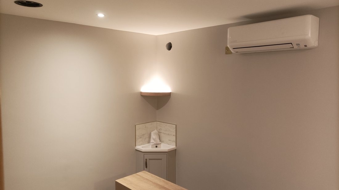 Interior wall with a wall light and air conditioning unit